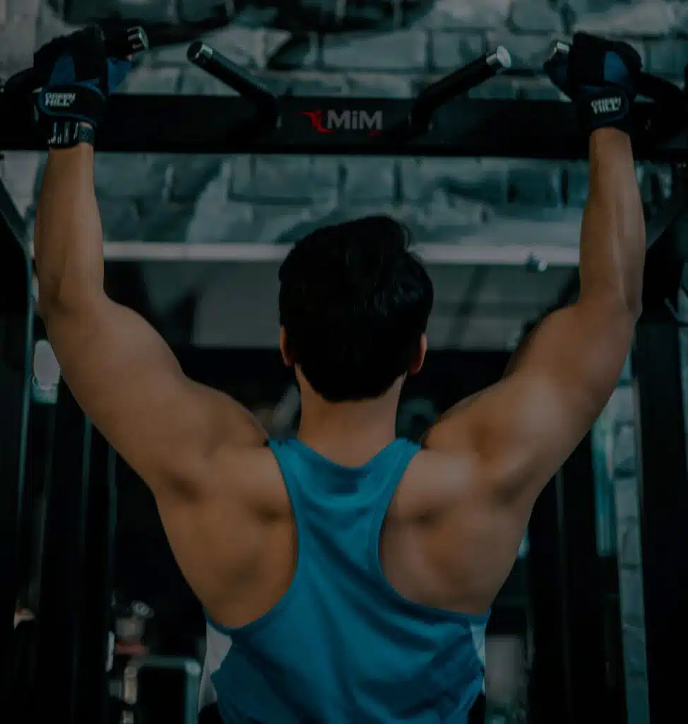 Man doing pull-ups in a gym