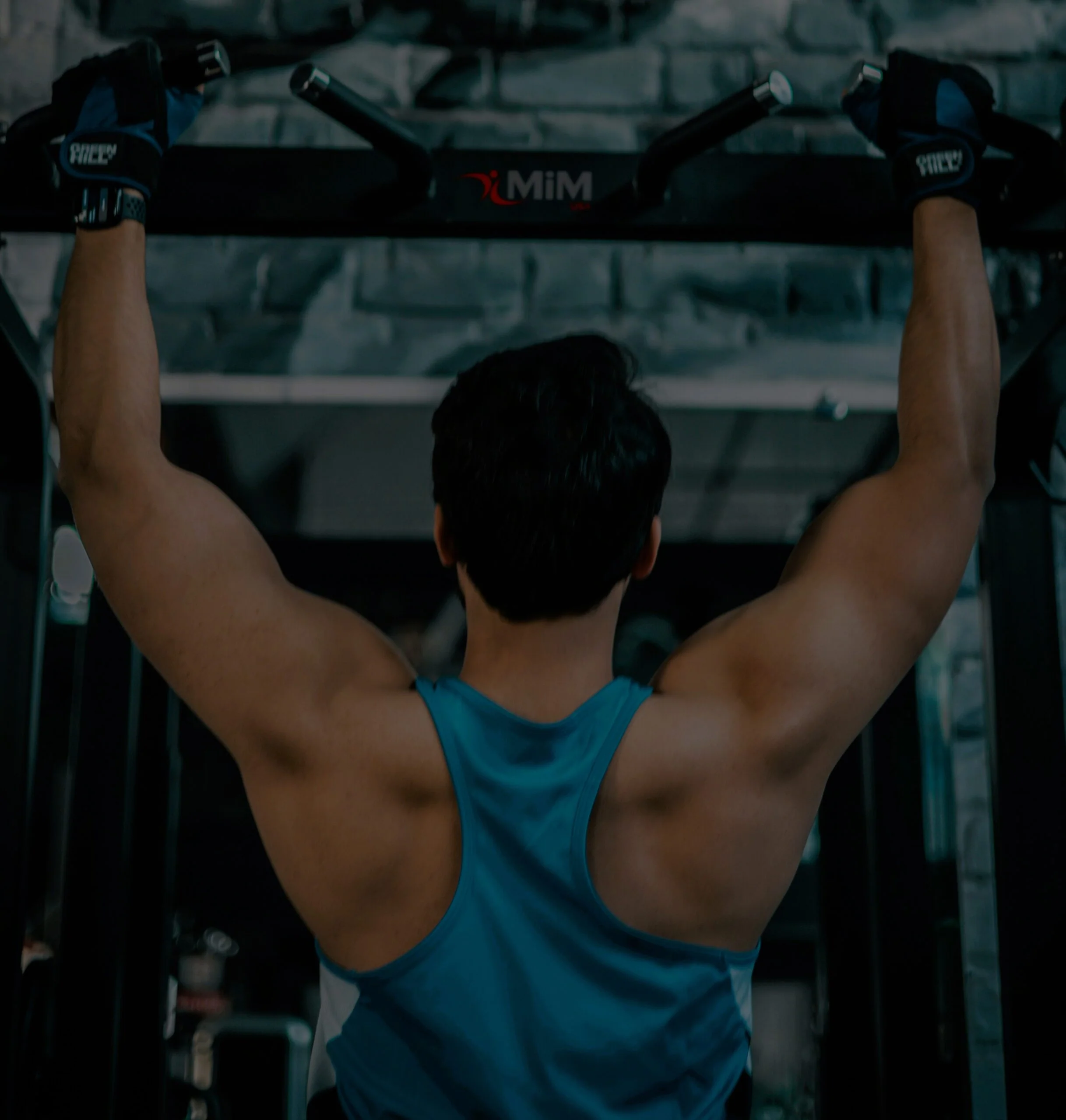 Man doing pull-ups at the gym